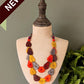 Colorful necklace on a mannequin bust with a 'NEW' label against a plain background