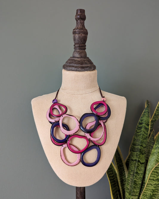 Colorful necklace on a mannequin bust with a gray background